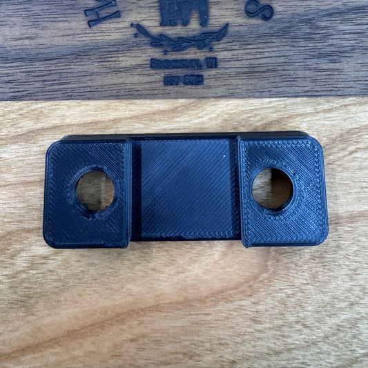 3D printed rear strap mount, underside with the two bolt holes and center channel
